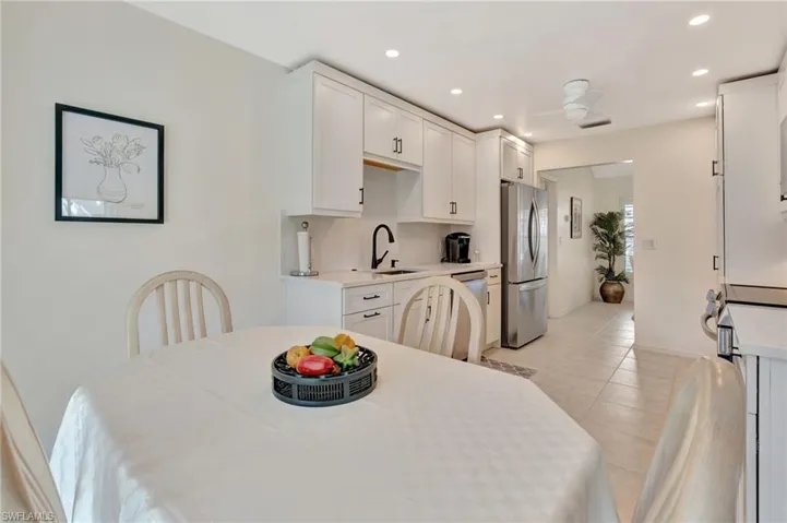 Dining area featuring recessed lighting and light tile patterned flooring