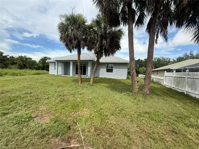 Rear view of property with stucco siding