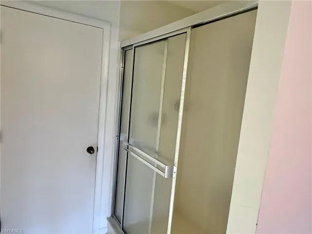 Bathroom with a shower with shower door