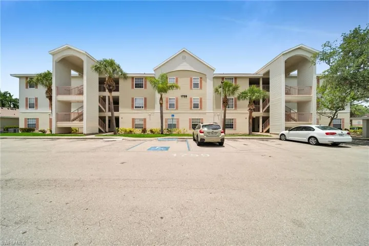 Three-story residential building with stucco exterior and integrated stairwells