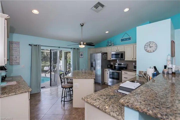 Kitchen featuring a  breakfast bar and gorgeous granite countertops