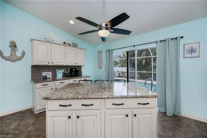 Huge island and coffee bar with additional cabinets-ceiling fan keeps kitchen cool in summer