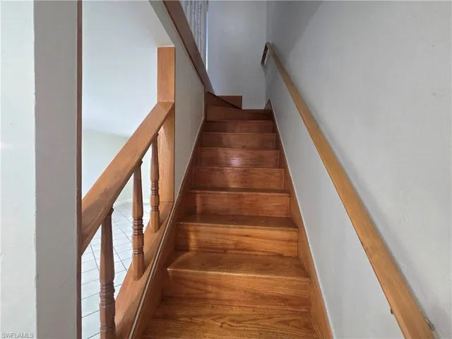 Wooden staircase leading to the 2 bedrooms & full bath.