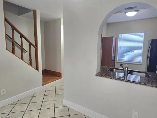 Kitchen pass-through, wooden staircase.