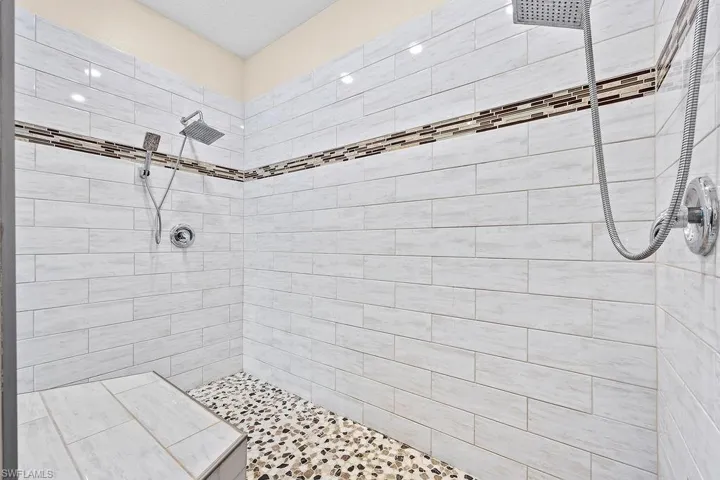 Bathroom with a tile shower, dual shower heads