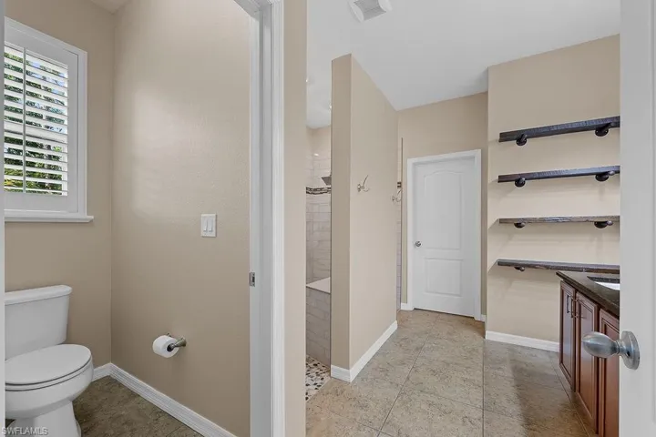 Bathroom with tile flooring, toilet, and vanity