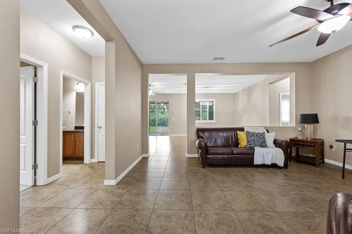 Tiled living room with ceiling fan- Open Floor Plan