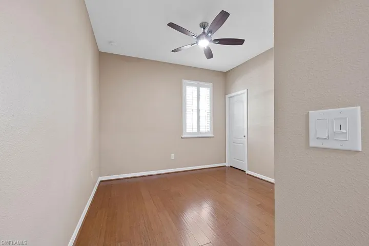 Spare room featuring hardwood / wood-style flooring and ceiling fan