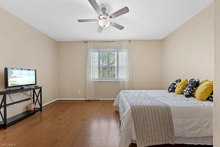 Bedroom featuring wood-type flooring and ceiling fan