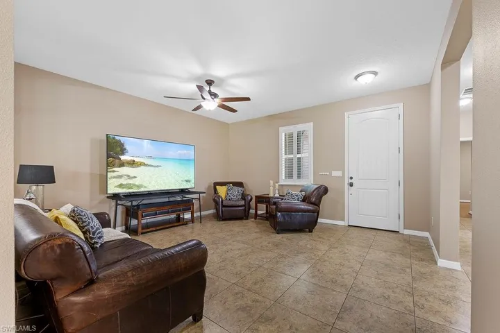 Living room with tile flooring and ceiling fan