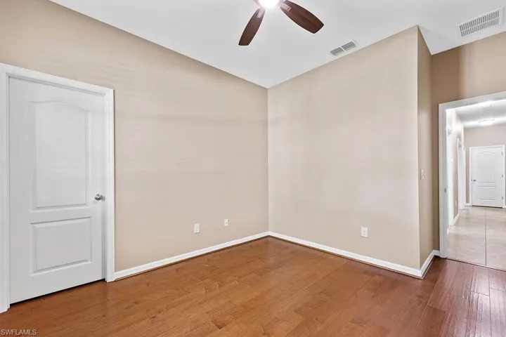 Empty room featuring wood-type flooring and ceiling fan