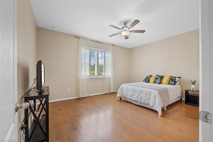 Bedroom featuring ceiling fan and hardwood / wood-style floors