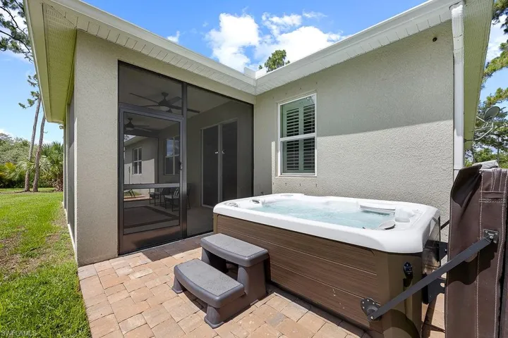 View of terrace featuring a hot tub