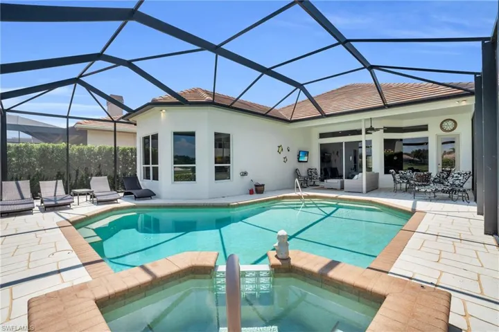 View of swimming pool with a lanai, a patio, and ceiling fan