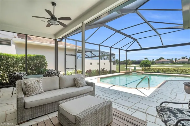 View of swimming pool featuring an outdoor hangout area, glass enclosure, ceiling fan, and a patio area