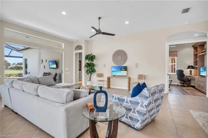 Tiled living room featuring ceiling fan