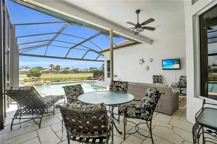 View of patio / terrace featuring glass enclosure and ceiling fan