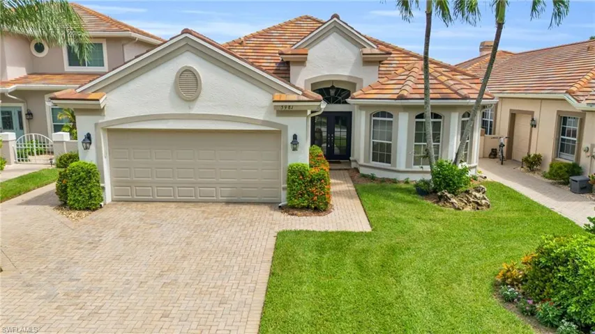 View of front facade with a front yard and a garage