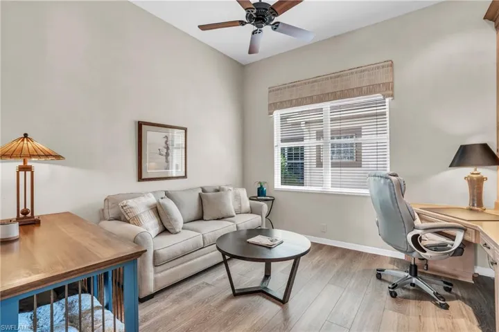 Home office with light hardwood / wood-style floors and ceiling fan