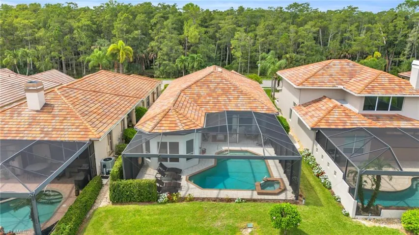 View of swimming pool with central air condition unit, a lawn, a lanai, and a patio area