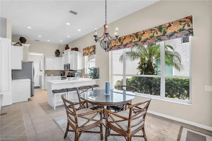 Tiled dining space featuring a chandelier