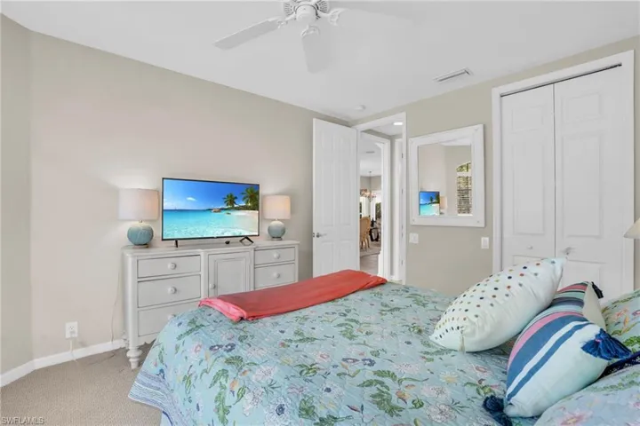 Bedroom featuring light carpet, a closet, and ceiling fan