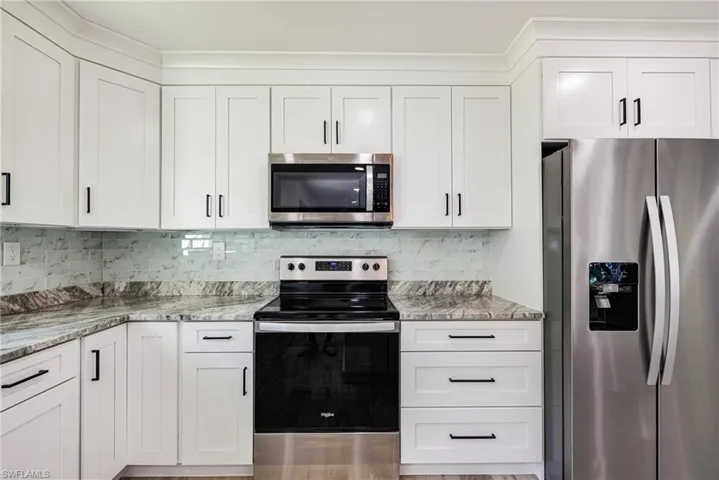 Kitchen with stainless steel appliances and white cabinets