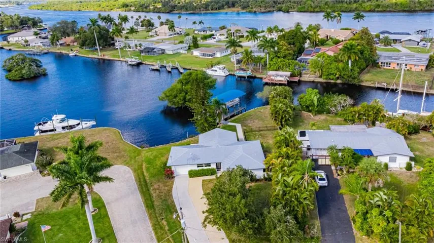 Aerial perspective of suburban area featuring a large body of water