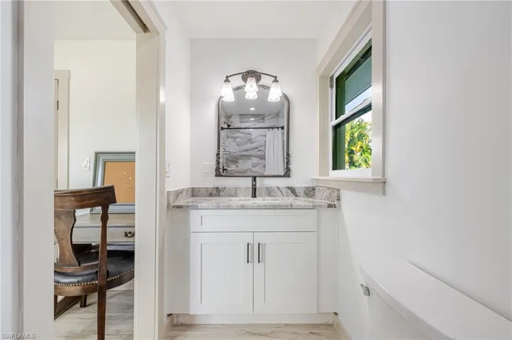 Bathroom featuring vanity and curtained shower