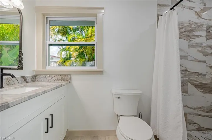 Full bathroom featuring vanity and a shower with curtain