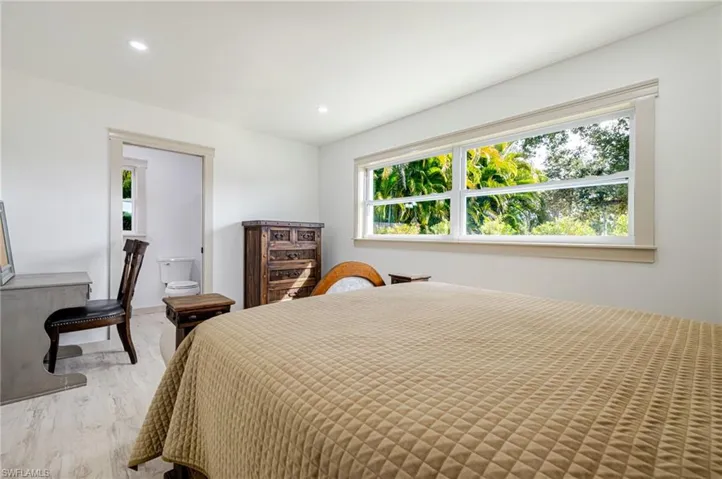 Bedroom featuring recessed lighting, multiple windows, and wood finished floors