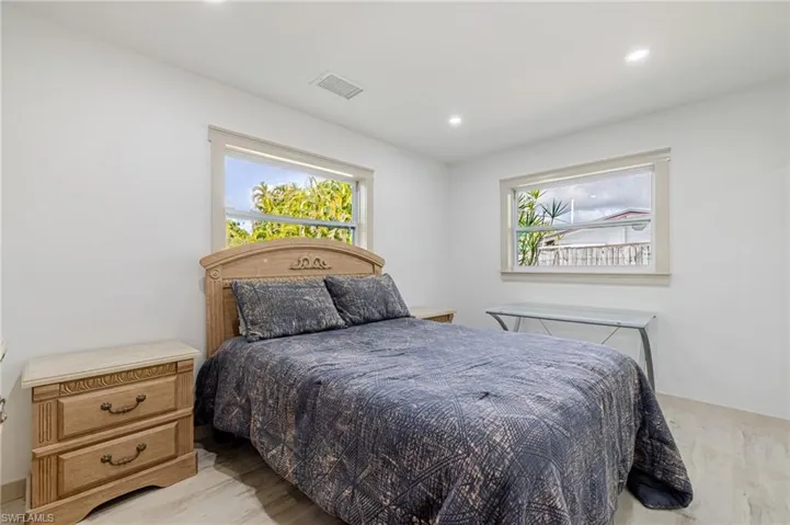 Bedroom with light wood-style floors and recessed lighting
