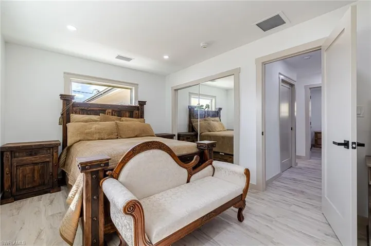 Bedroom with a closet, light wood finished floors, and recessed lighting