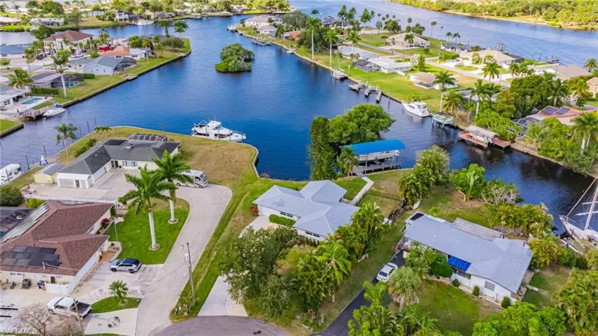 Aerial view of residential area featuring a nearby body of water
