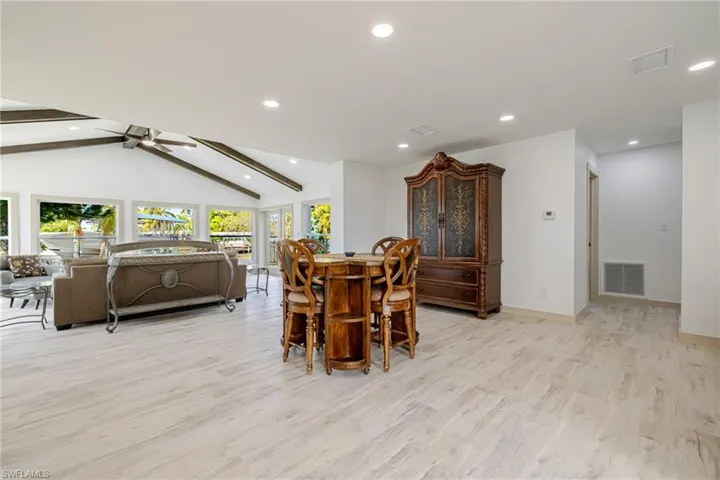 Dining room with light wood finished floors, a ceiling fan, and recessed lighting