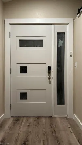 Doorway featuring a barn door and hardwood / wood-style flooring