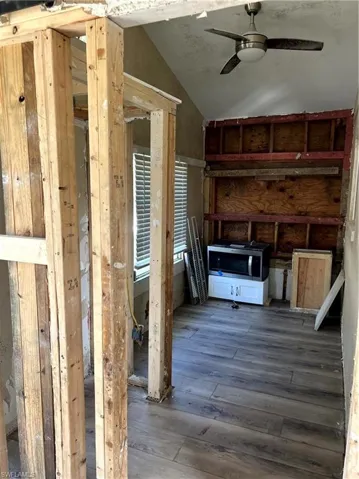 Miscellaneous room with hardwood / wood-style flooring, ceiling fan, and lofted ceiling