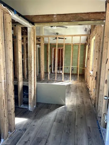 Misc room featuring a wall unit AC and dark hardwood / wood-style flooring