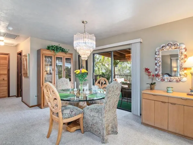 Dining room featuring light carpet and an inviting chandelier