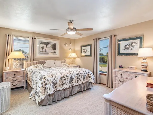Bedroom featuring light carpet and ceiling fan
