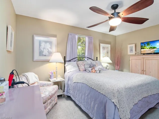Carpeted bedroom with ceiling fan
