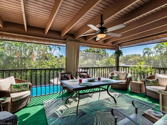 Sunroom with ceiling fan and beamed ceiling