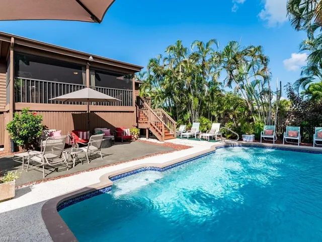 View of pool with a patio and a sunroom