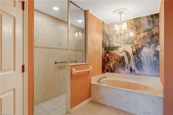 Bathroom with a walk in shower, a garden tub, tile patterned flooring, hanging lights, and ornamental molding