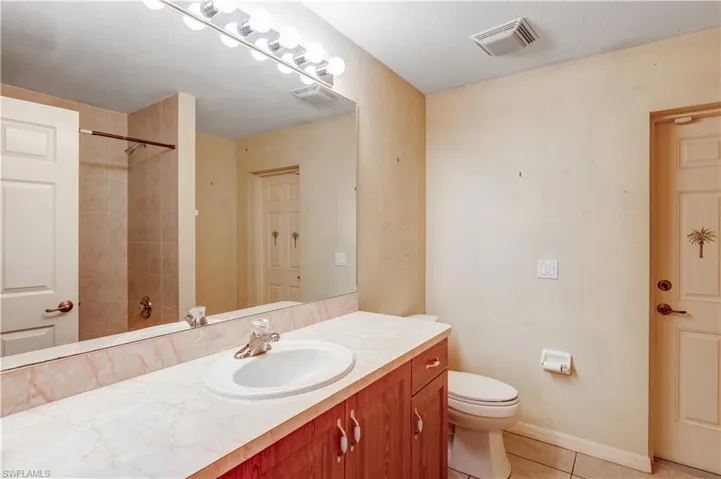 Full bathroom featuring vanity and light tile patterned floors