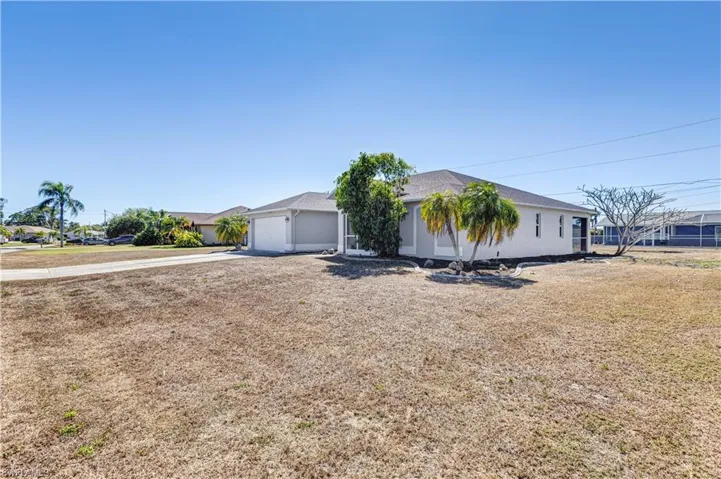 Ranch-style house with concrete driveway and a garage