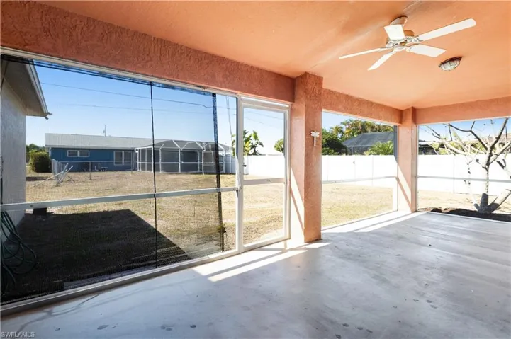 Unfurnished sunroom featuring lofted ceiling