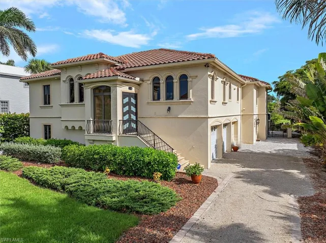Mediterranean / spanish home with an attached garage, stucco siding, and driveway