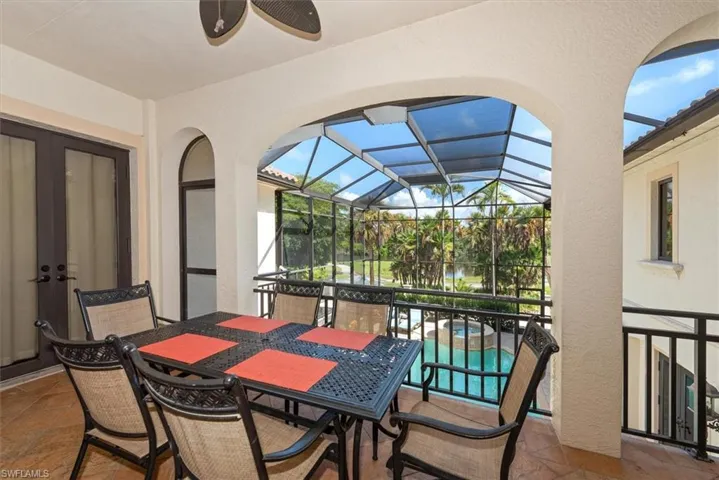 View of patio / terrace with a sunroom, glass enclosure, outdoor dining area, and ceiling fan