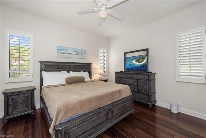 Bedroom with dark wood-style floors and a ceiling fan